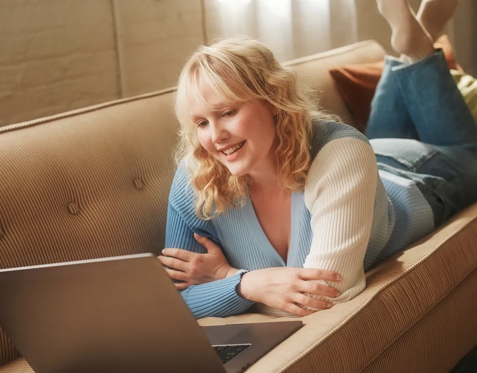 Patient lying down on a couch in an online therapy session